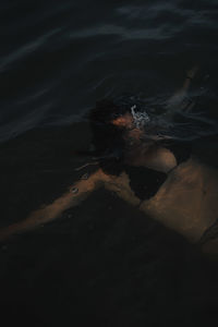 High angle view of woman swimming in sea