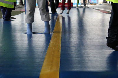 Low section of woman standing on tiled floor