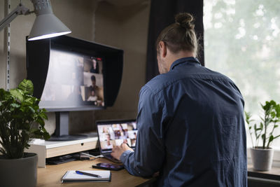 Man attending video conference from home