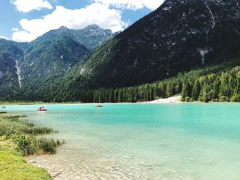 Scenic view of lake and mountains against sky