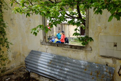 People sitting by wall