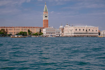 View of canal and buildings against sky