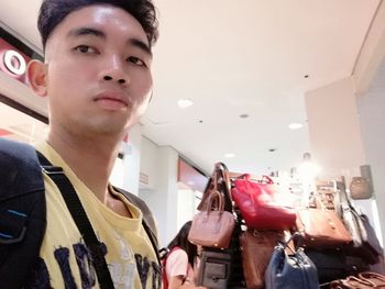 Portrait of young man standing in store