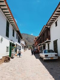 View of street amidst buildings in city