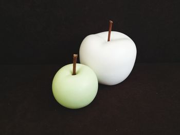 Close-up of apple on table against black background