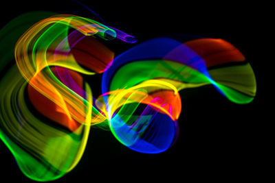 Close-up of multi colored bubbles over black background