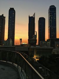 View of skyscrapers in city during sunset