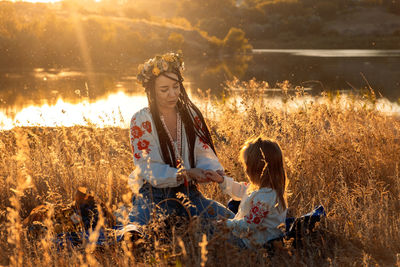 Global view, real life around the globe, local living. mom and daughter in national clothes and