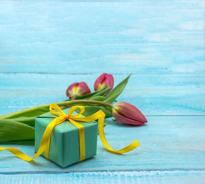 Spring flowers and a gift box. red tulips and red packaging.