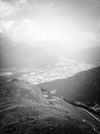 Scenic view of sea and mountains against sky