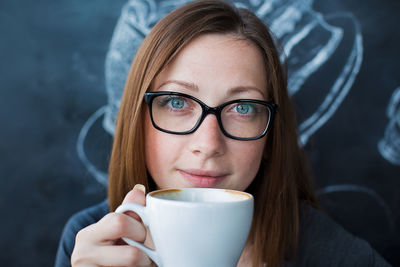 Portrait of smiling woman holding coffee