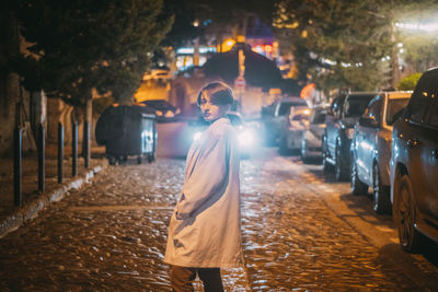 Rear view of woman walking on street in city