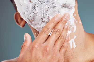 Cropped image of man holding wedding dress