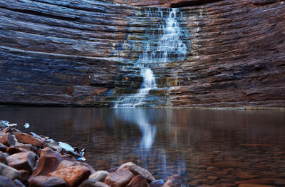 Scenic view of waterfall against sky
