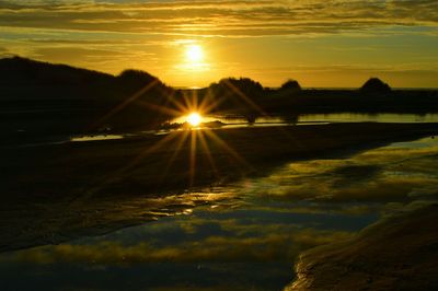 Scenic view of lake at sunset