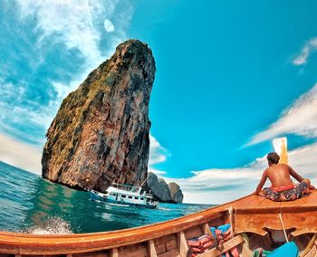 Scenic view of sea and rock formation against sky