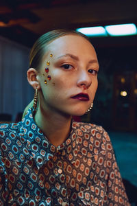 Close-up portrait of young woman looking away