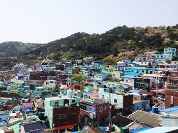 Aerial view of houses and trees against clear sky