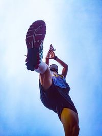 Low angle view of man playing basketball against sky