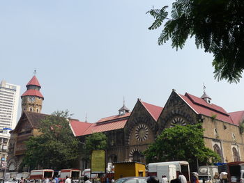 Buildings in city against clear sky