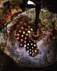 High angle view of rusty metal on rock