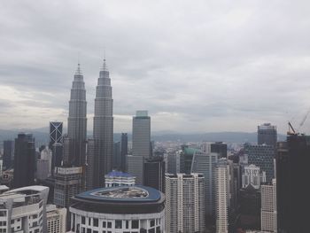 City skyline against cloudy sky