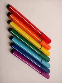 High angle view of colored pencils against white background