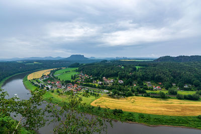 Scenic view of river amidst field against sky