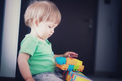 Cute boy sitting on floor