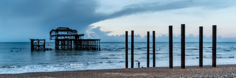 Brighton west pier lone photographer taking photo of pier out to sea