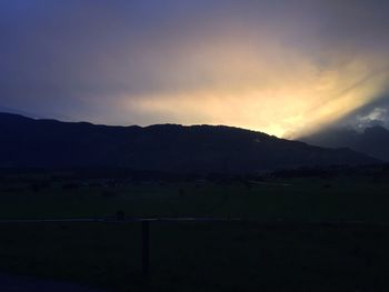 Scenic view of mountains against sky at sunset