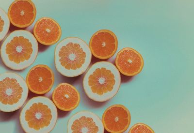 Close-up of orange fruits against blue background