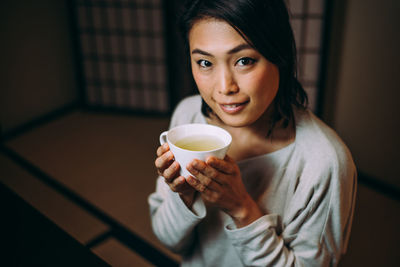 Portrait of woman drinking coffee