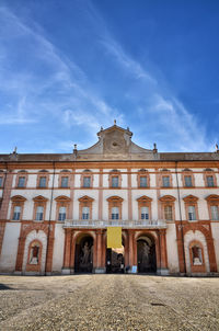 Low angle view of historic building against blue sky