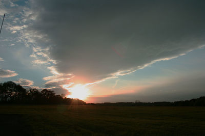 Sunset over grassy field