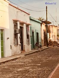 Empty alley amidst buildings in city