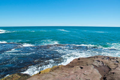 Scenic view of sea against clear blue sky