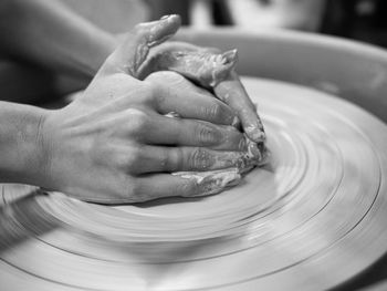 Cropped hand of person working with pottery