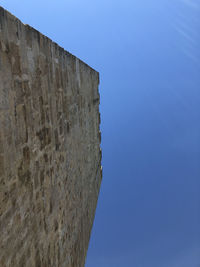 Low angle view of fort against clear blue sky