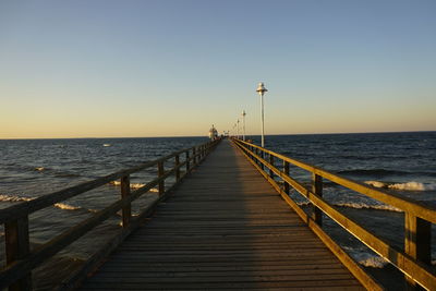 Pier over sea against clear sky