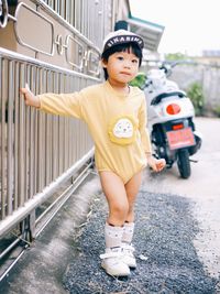 Full length of young woman standing on road