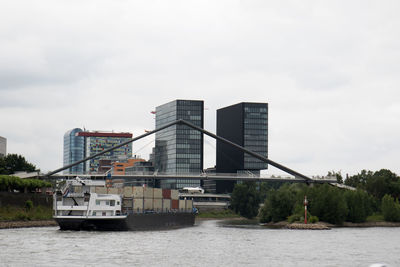 Built structure by river against sky