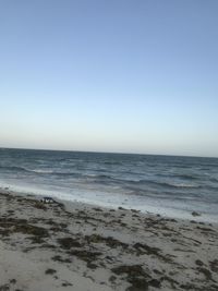 Scenic view of beach against clear sky