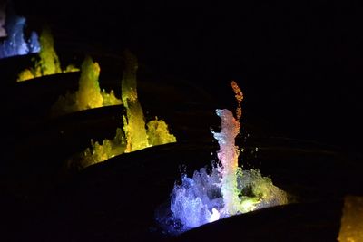 Close-up of illuminated water against black background
