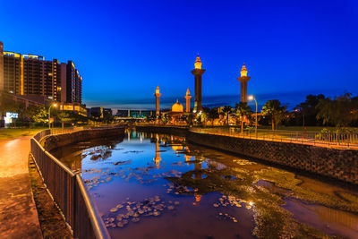 Reflection of illuminated buildings in lake at night