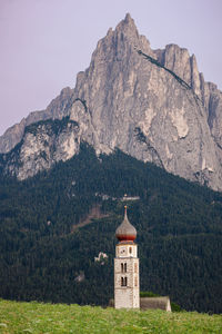 Summer flowers, church and mountain, south tyrol, italy