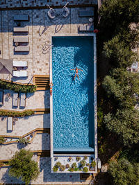 Aerial view of man floating on water in swimming pool