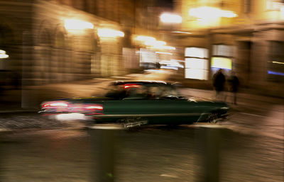 Blurred motion of car on illuminated city at night