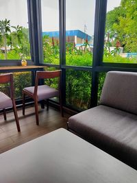 Empty chairs and table against window at home