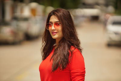 Portrait of young woman standing outdoors